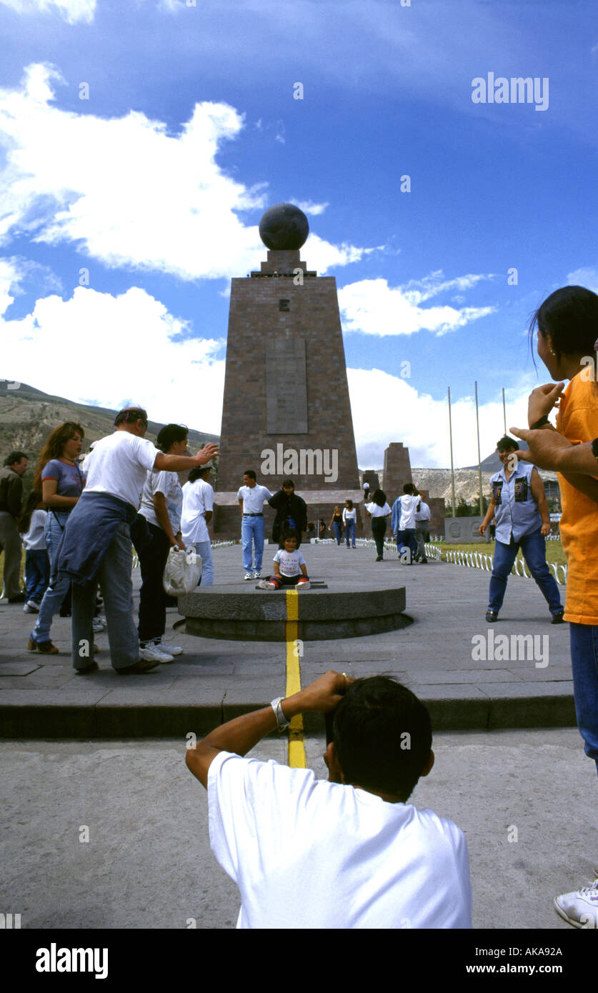 Tourists taking pictures of the yellow line wich divides the two hemispheres Center of the World Monument Near Quito Ecuador Stock Photo