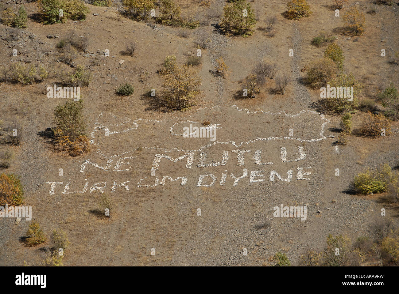 Writing in Turkish reads 'How happy is the one who says I am a Turk' in a remote mountainous area near the border with Iraq in Turkey Stock Photo