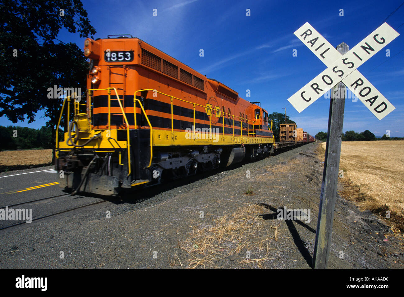 Train at railroad crossing Stock Photo