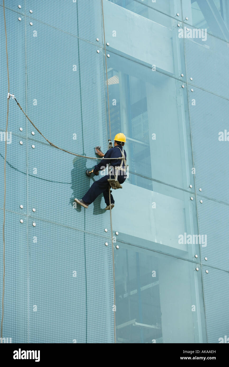 Window washer on side of office building, close-up Stock Photo