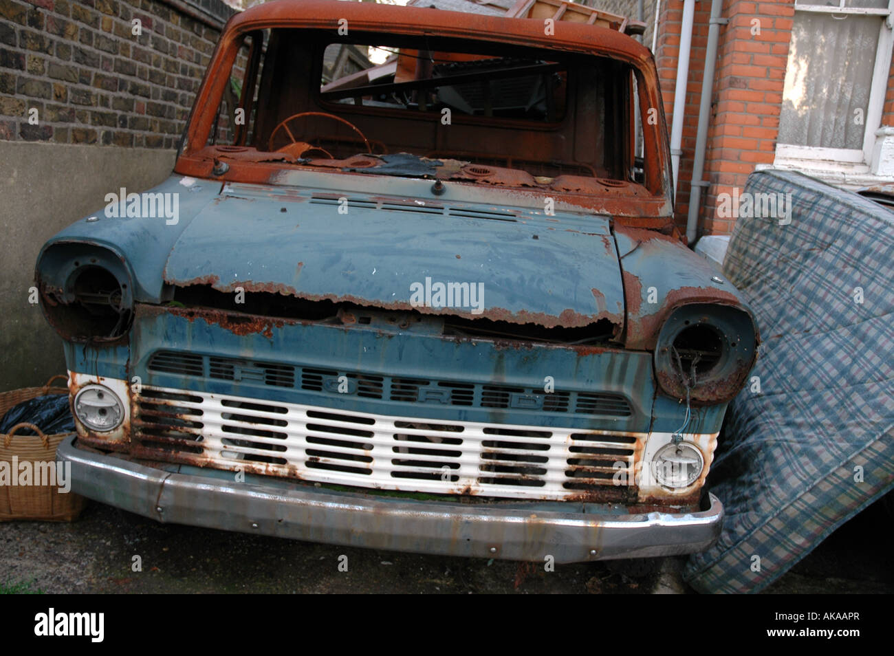 rusting stripped blue transit van Stock Photo