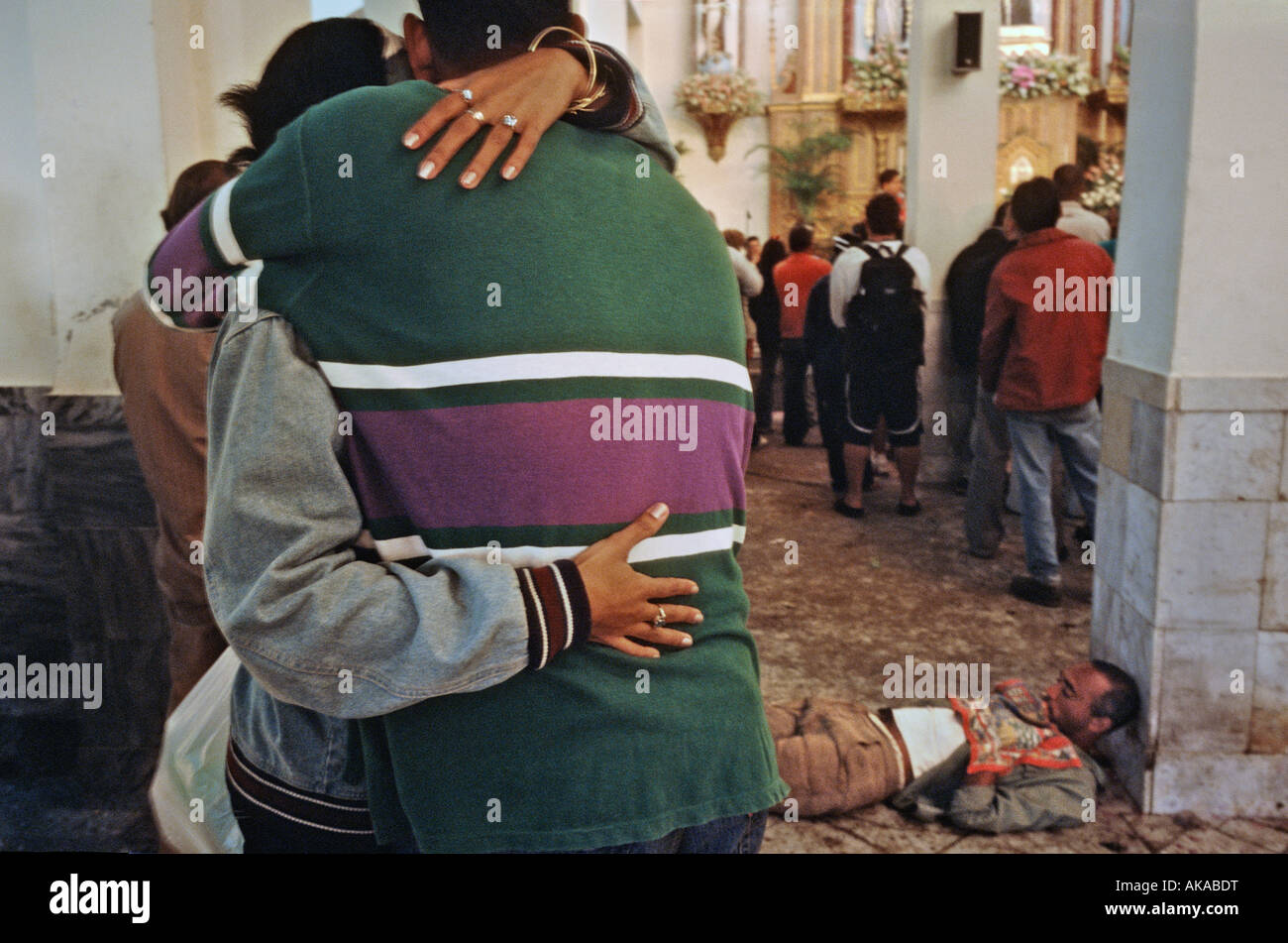Couple embracing inside the shrine of St Lazarus. Rincon Cuba Stock Photo