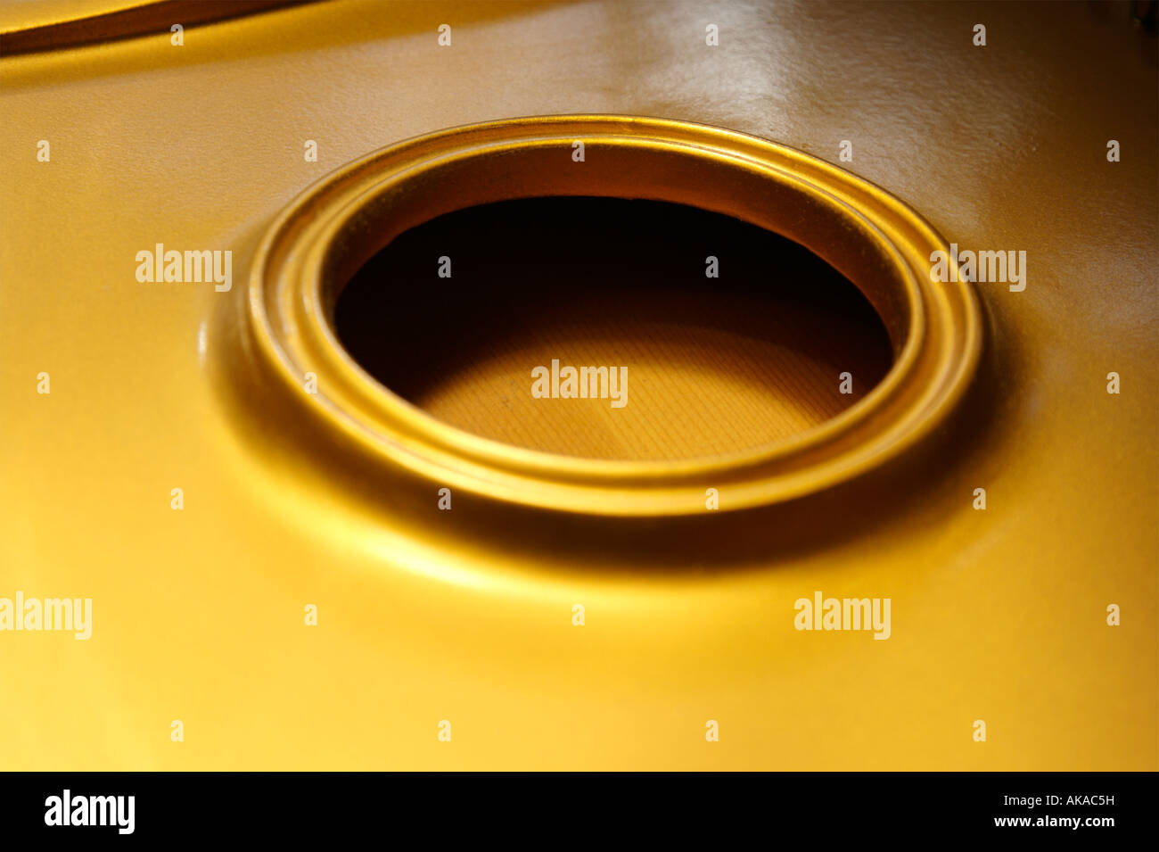 A Circle on a gold piano soundboard Stock Photo
