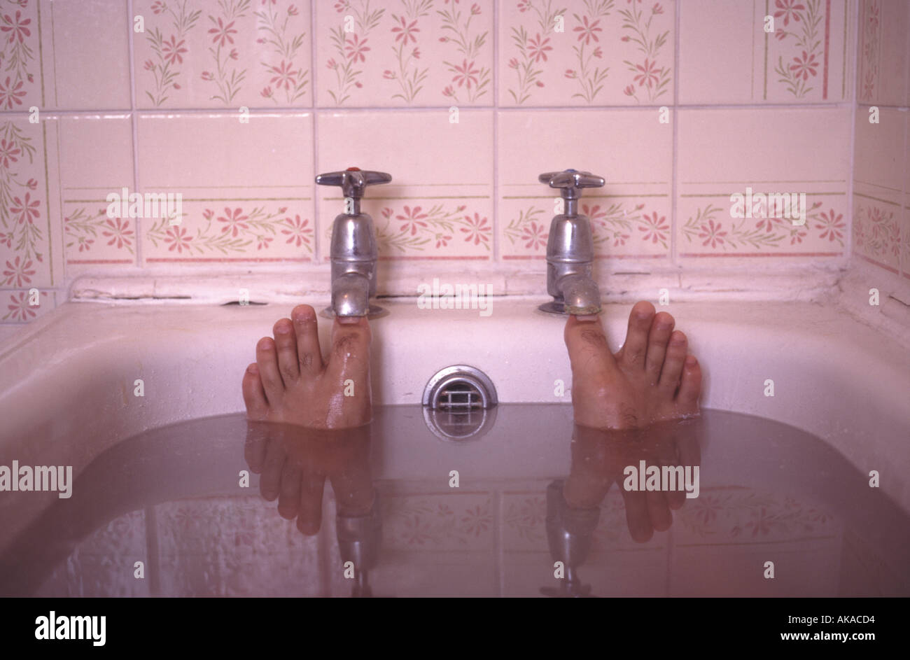 Toes Plug Taps in Bath Stock Photo