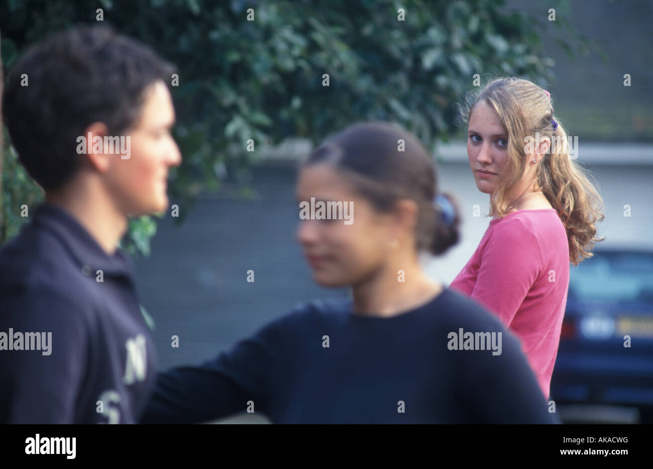 girl looking jealously at another girl with a boy Stock Photo