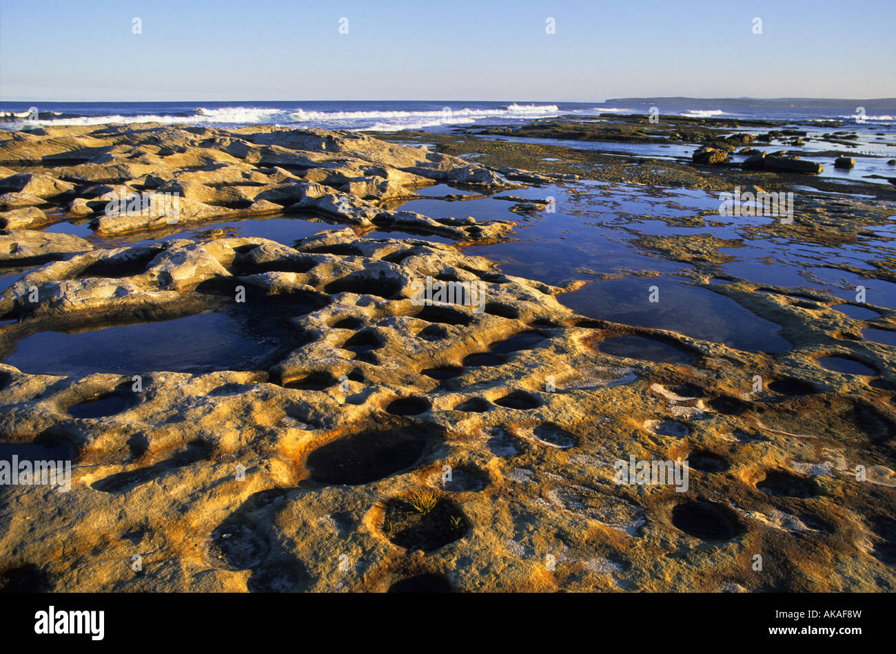 Natural rock formations on a beach at low tide Kunell NSW Australia Stock Photo