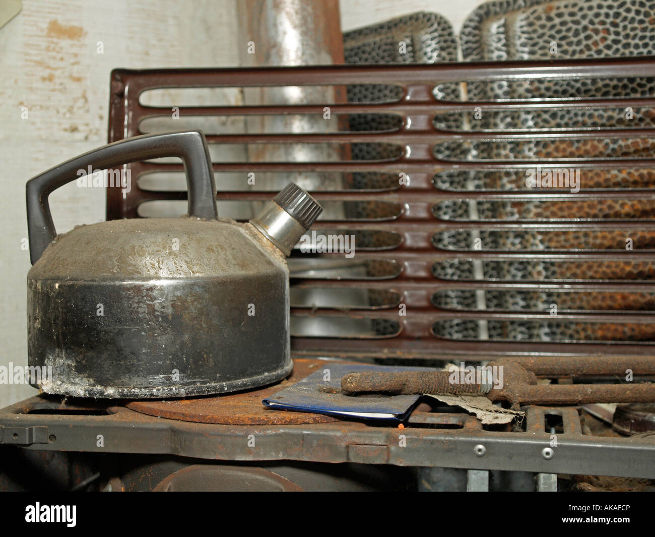 old dirty rusty water kettle on an old oil oven Stock Photo Alamy