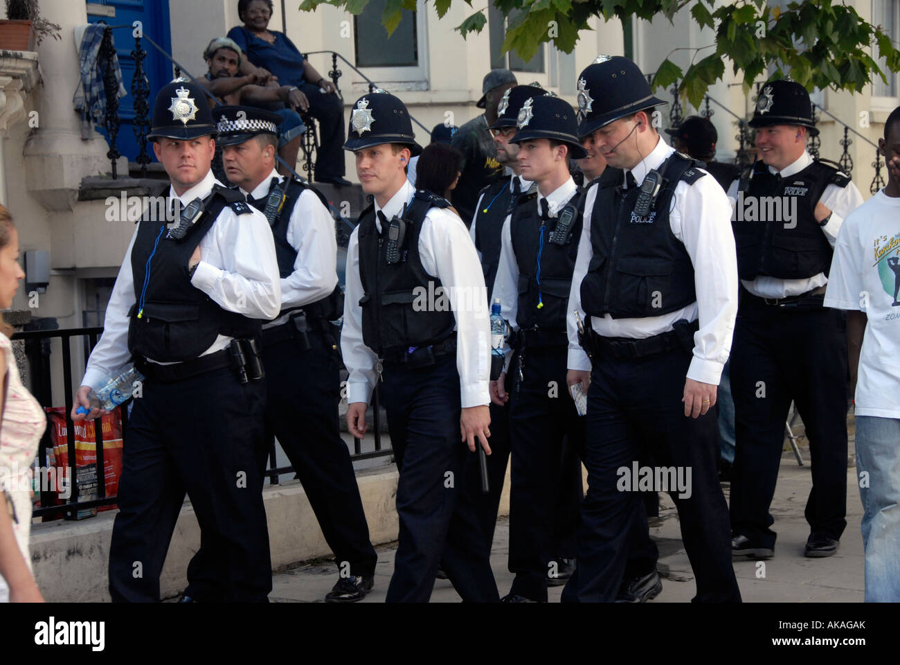 Group of police rushing through streets of West London Stock Photo