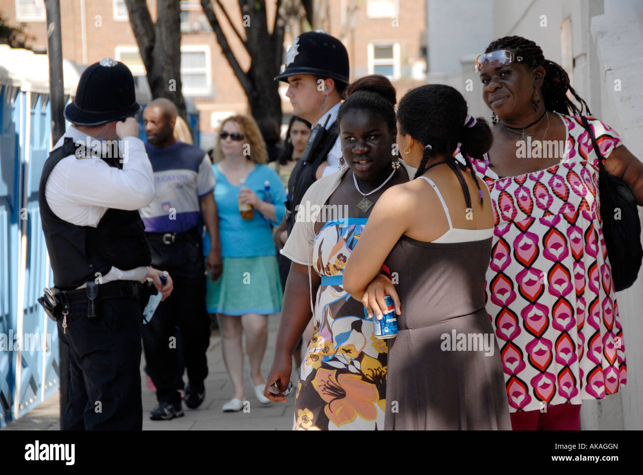 Group of women chatting on street corner police behind Stock Photo