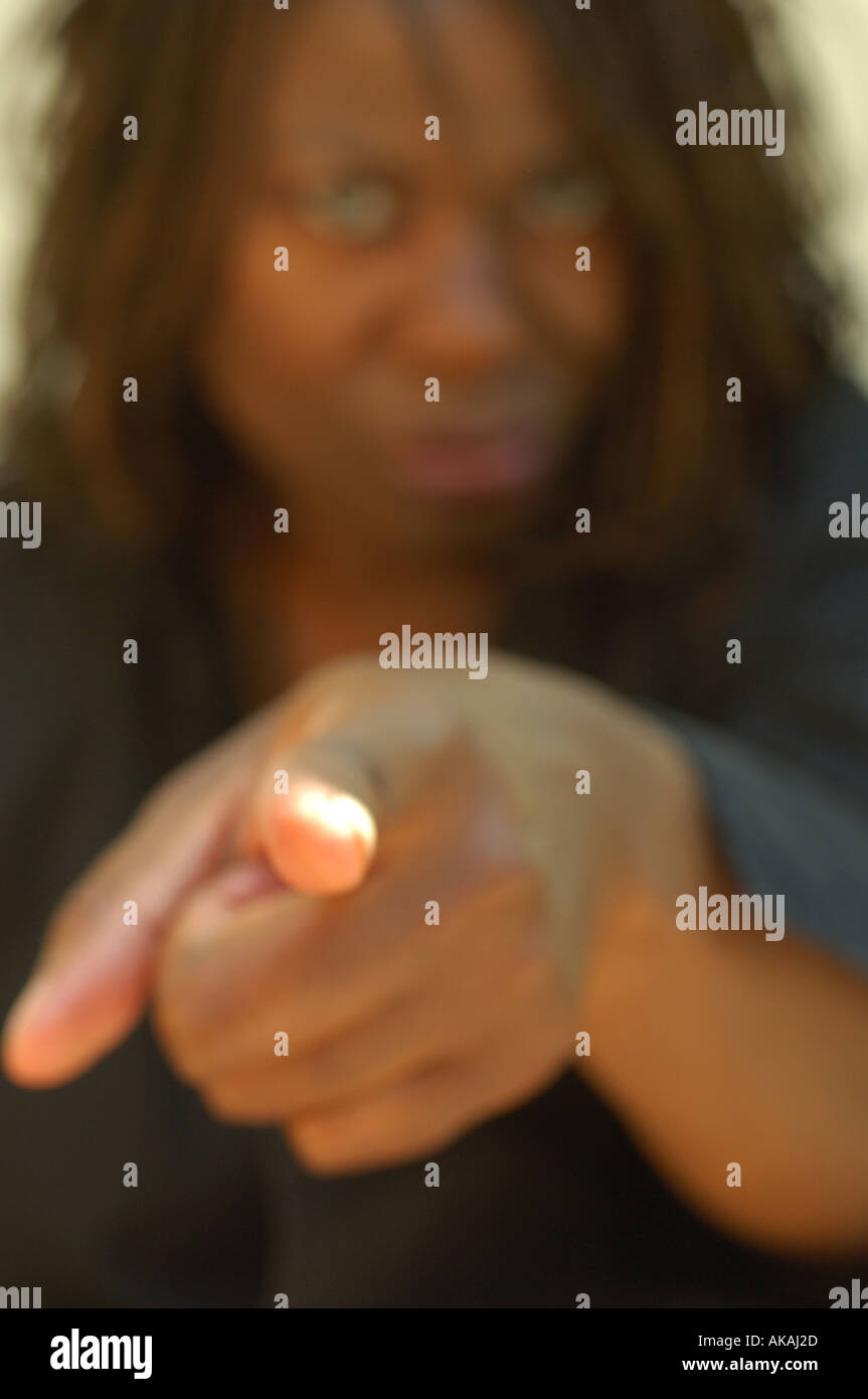 Moody Black Woman pointing Stock Photo