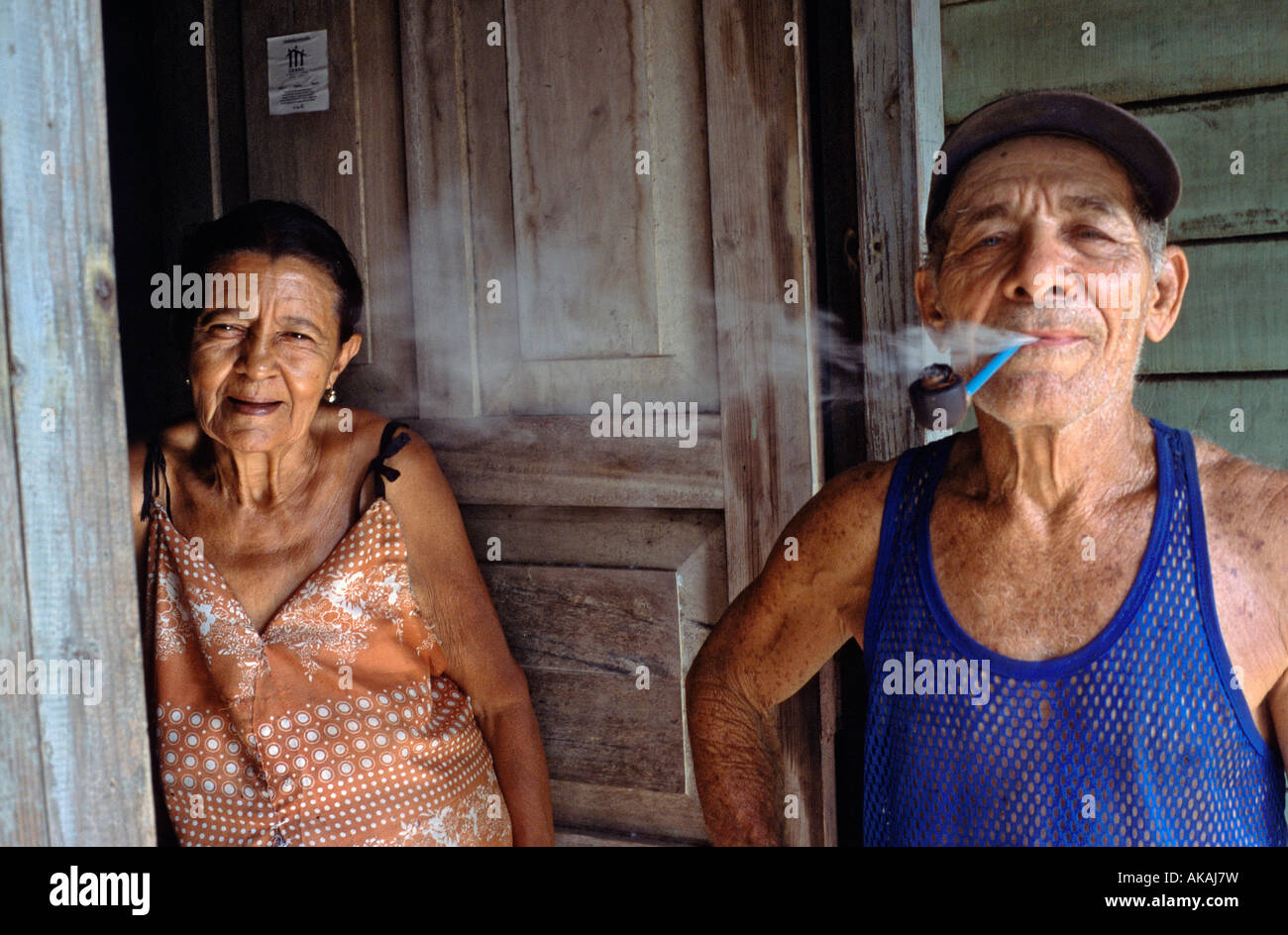 Retired cocotero or coconut worker with his wife in front of their home on a coconut plantation near Baracoa Cuba Stock Photo