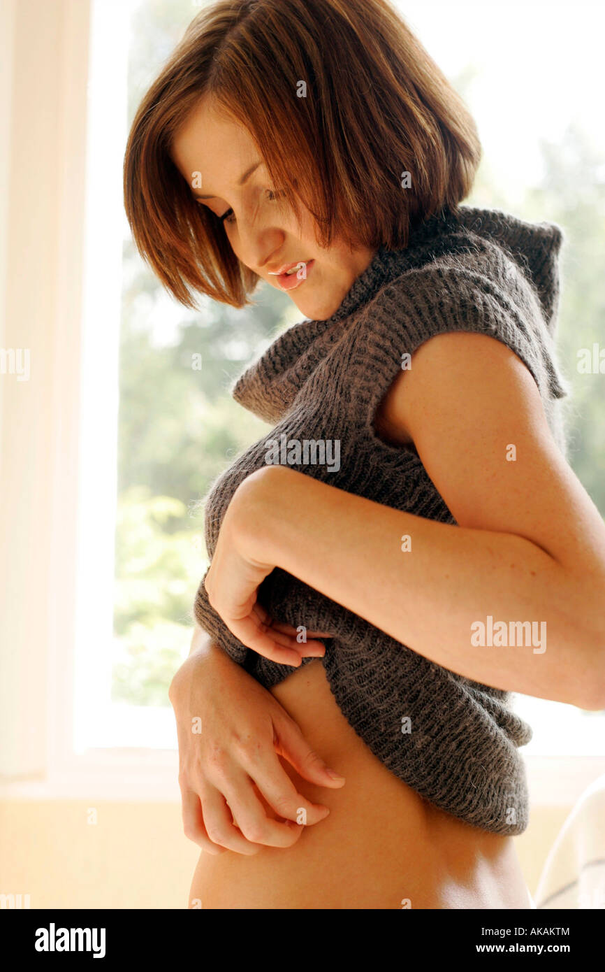 woman in jumper scratching Stock Photo