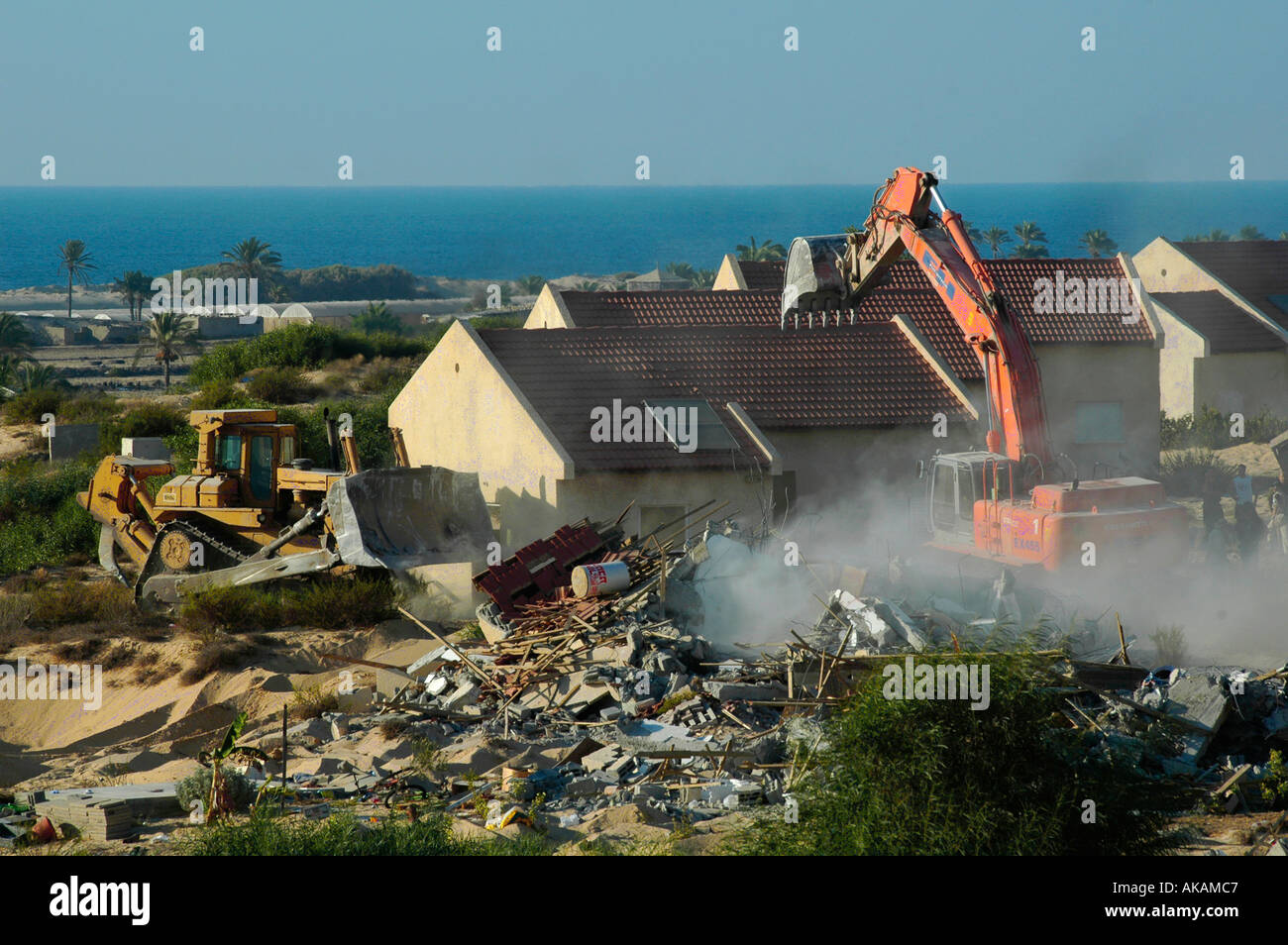 Israeli bulldozers demolish abandoned houses of Jewish settlers in what used to be the settlement of Peat Sade in Gaza Strip Stock Photo
