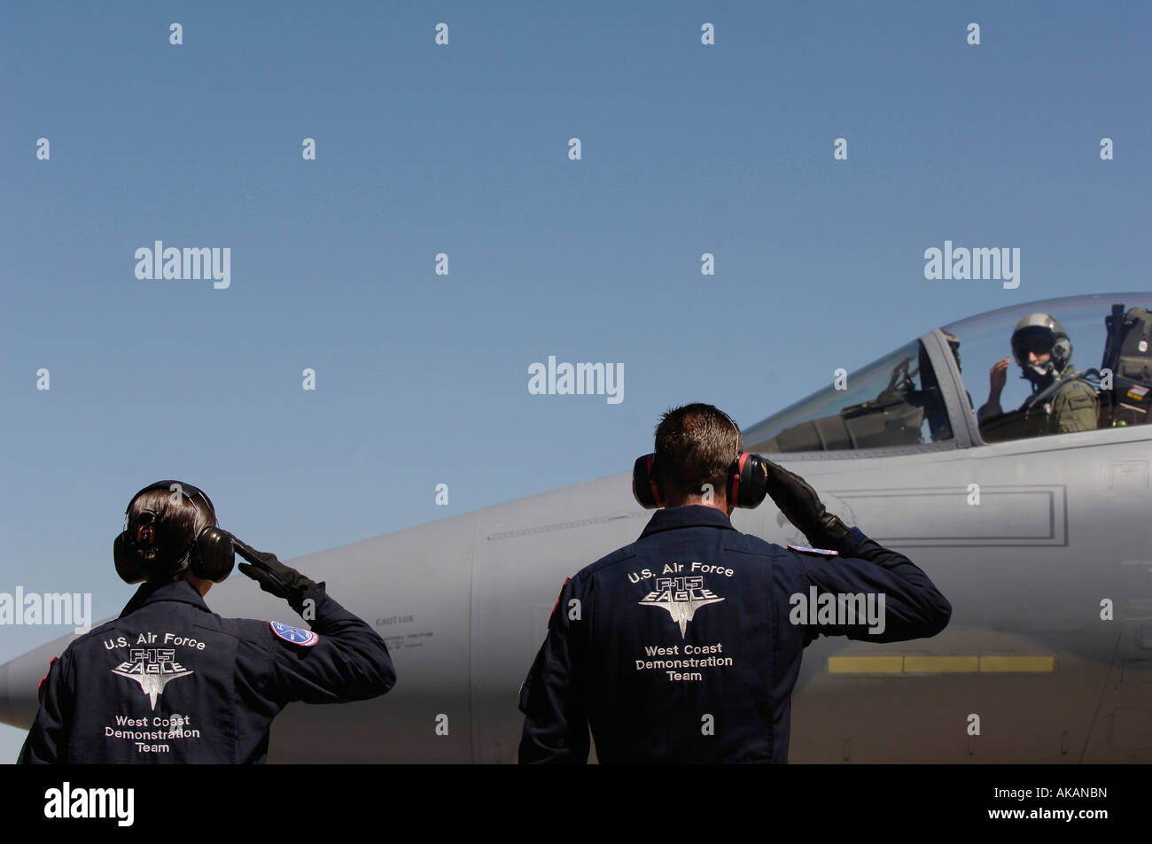 U.S. Air Force Airmen salute the Captain of an F-15 Eagle. Stock Photo