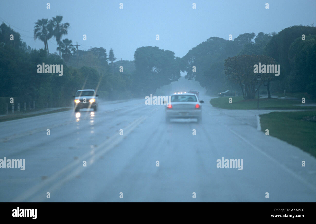 Cars driving with lights on in heavy rain and poor driving conditions on  Florida highway USA Stock Photo