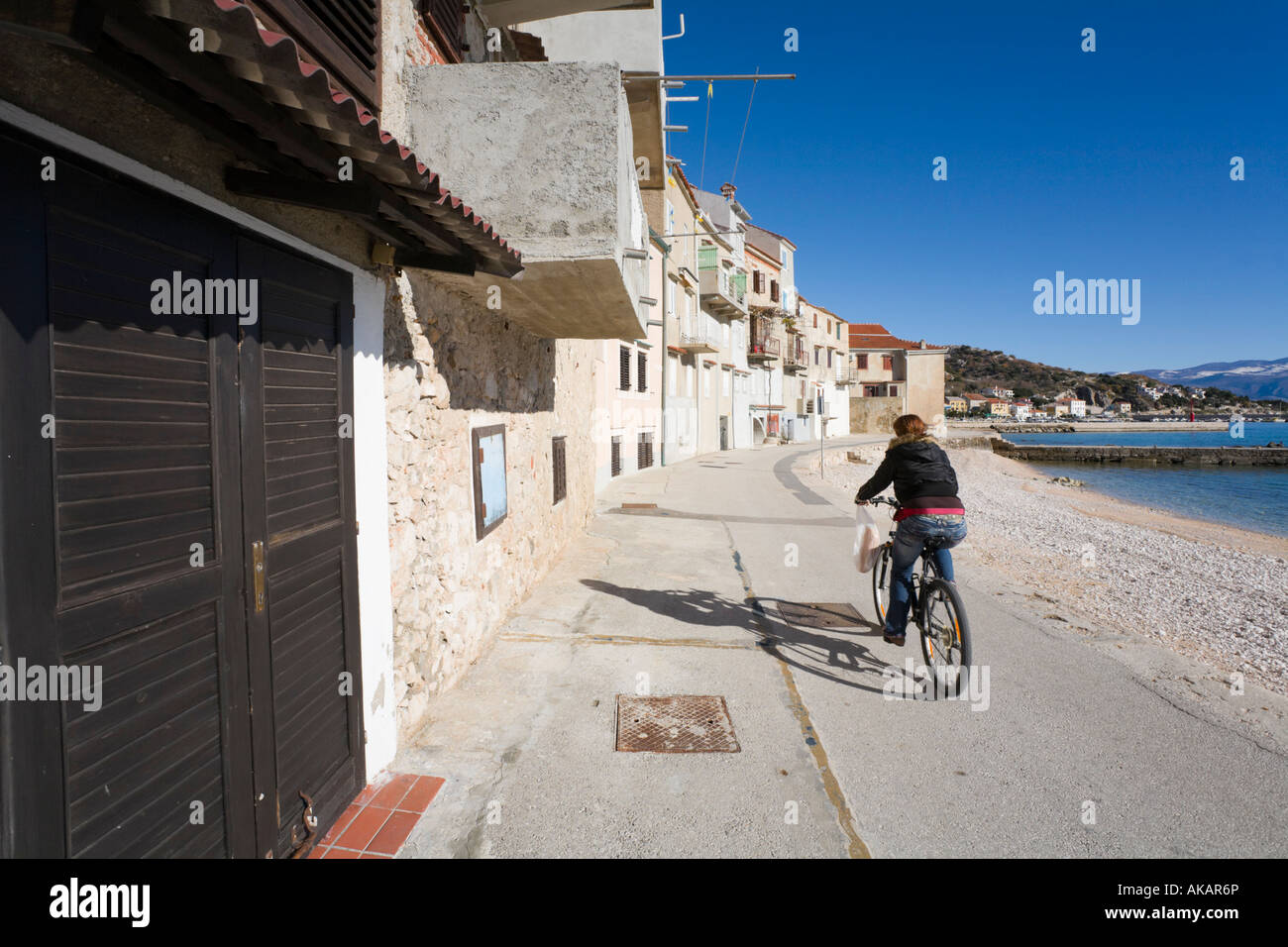 Baska on Krk island in Croatia, lonesome biker passing by Stock Photo