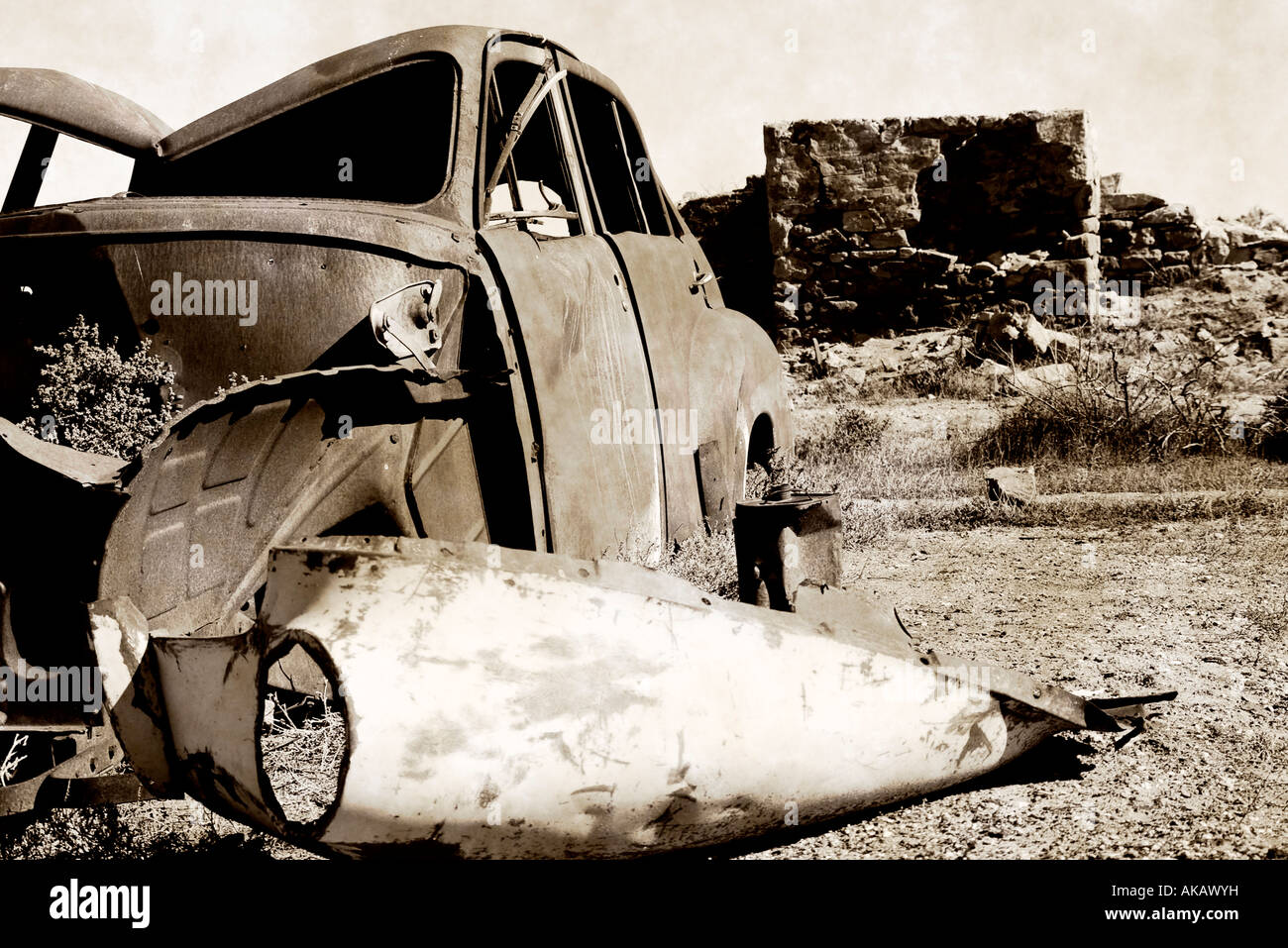 black and white image an old rusting car and ruins in the desert Stock ...