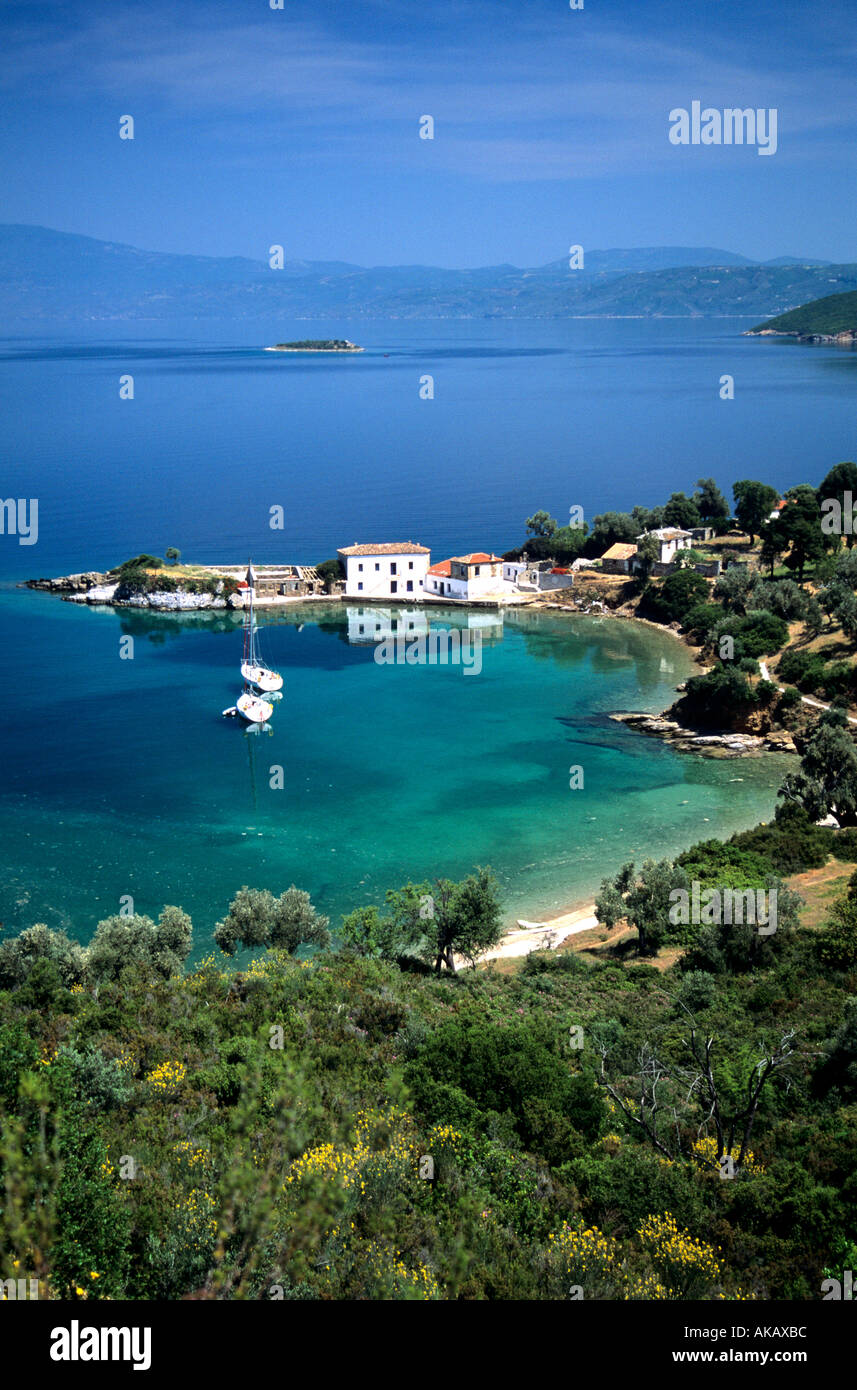 View of yachts anchored in little bay Gulf of Volos Greece with white buildings and houses on headland Stock Photo