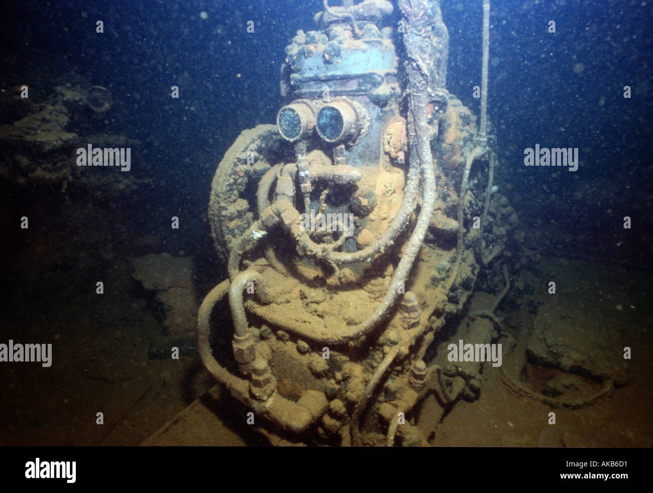 Though covered in decades of underwater sediment this sunken air compressor from the Fujikawa Maru resembles a futuristic robot Stock Photo