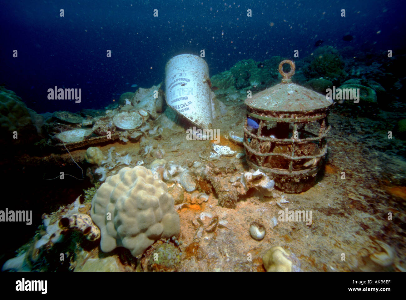 Artifacts such as this bent and beaten ship s lantern are found scattered upon the World War II graveyard the wreck of the Heian Stock Photo