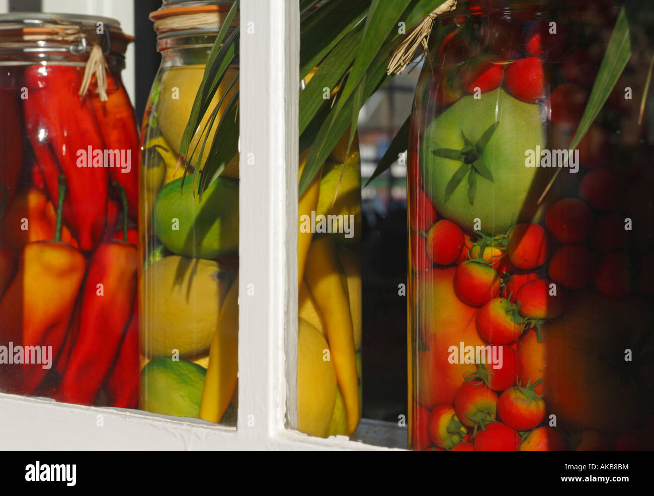 Jars of replica preserved fruit in a window Stock Photo Alamy