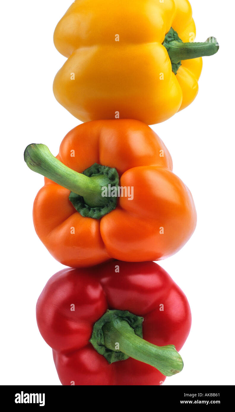 Stack of yellow orange and red bell peppers Stock Photo