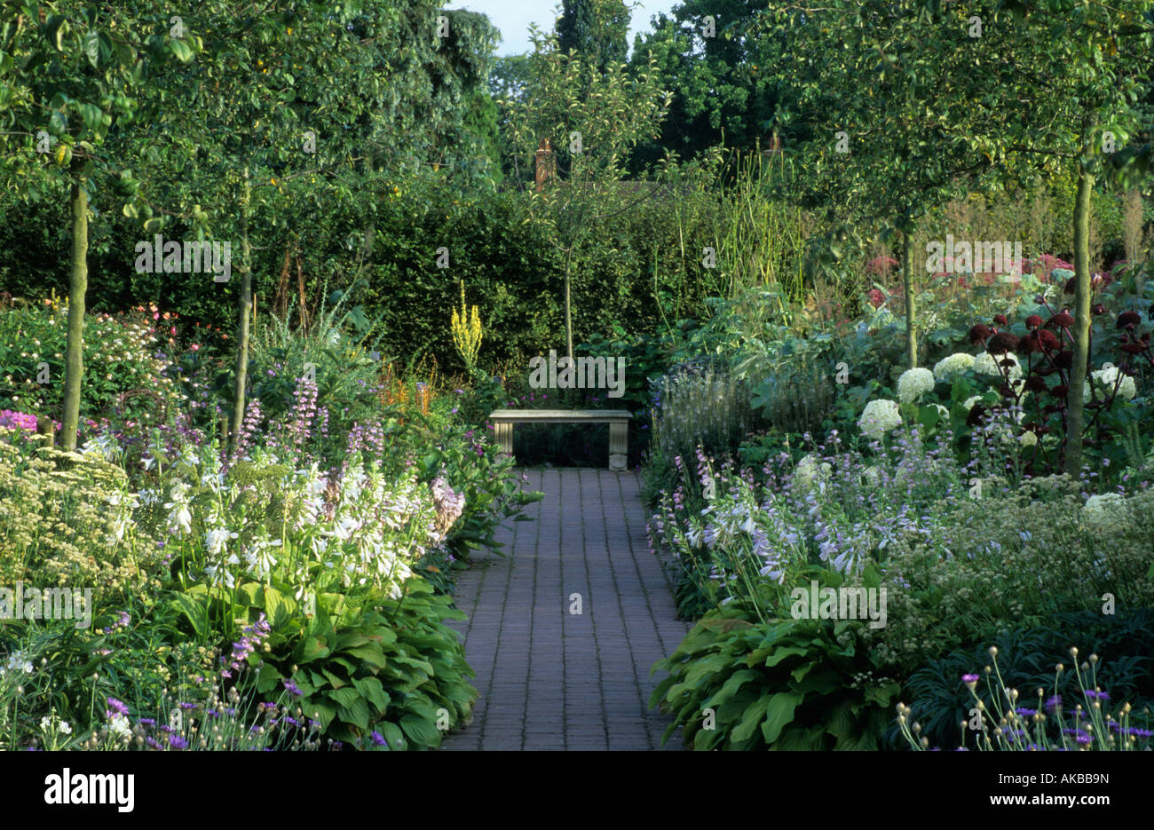 RHS Wisley Surrey design Penelope Hobhouse white borders with path between and bench seat as focal point Stock Photo