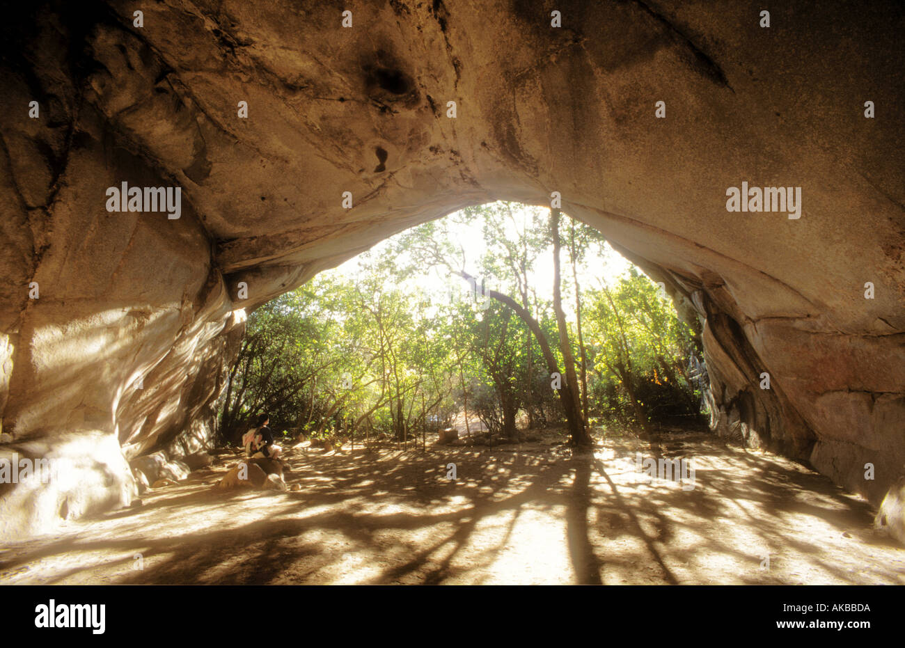 Entrance to Pomongwe Cave Zimbabwe which contains cave paintings with figure in middle distance Stock Photo