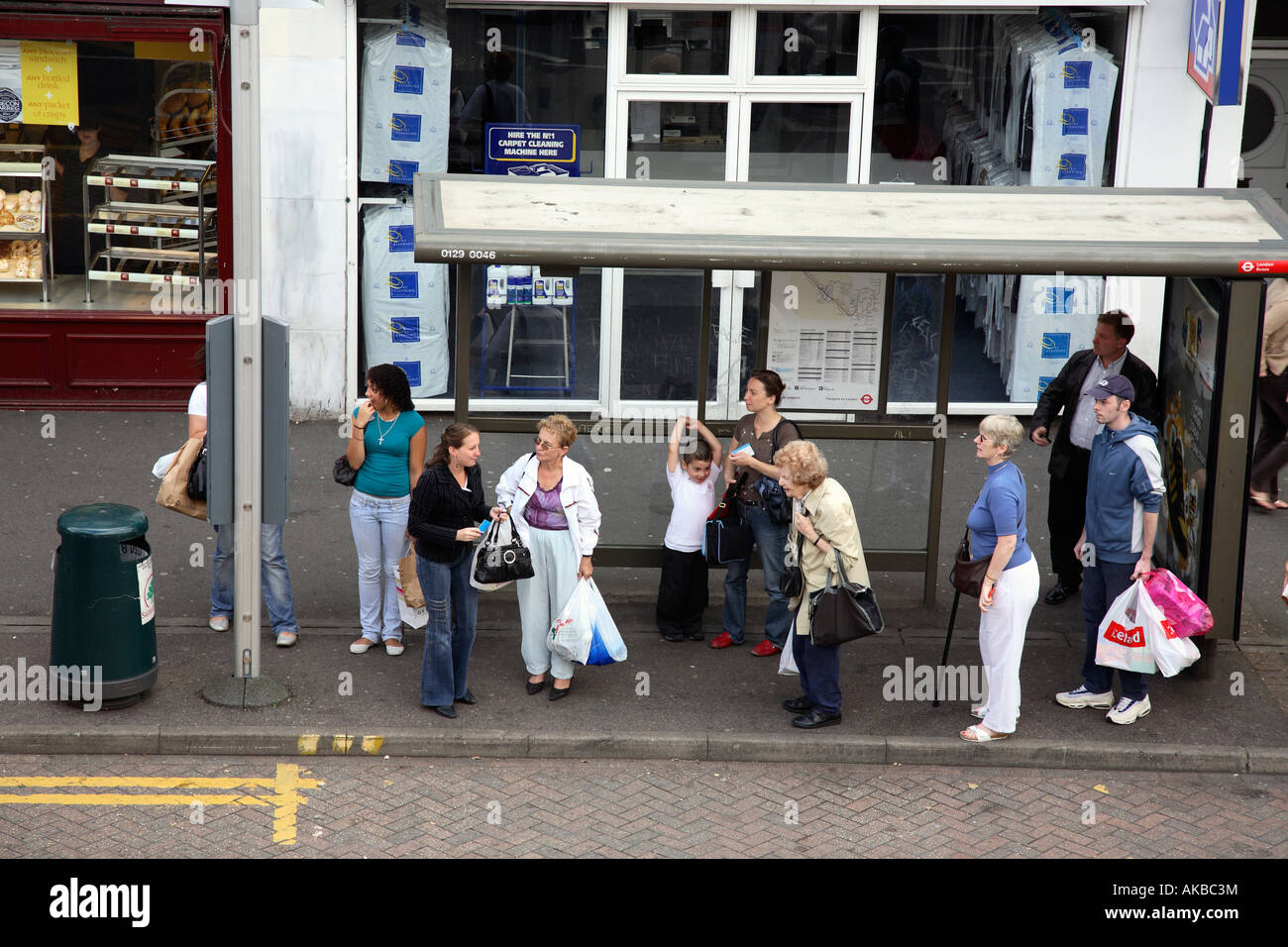 People waiting at a bus stop in London Uk. Stock Photo