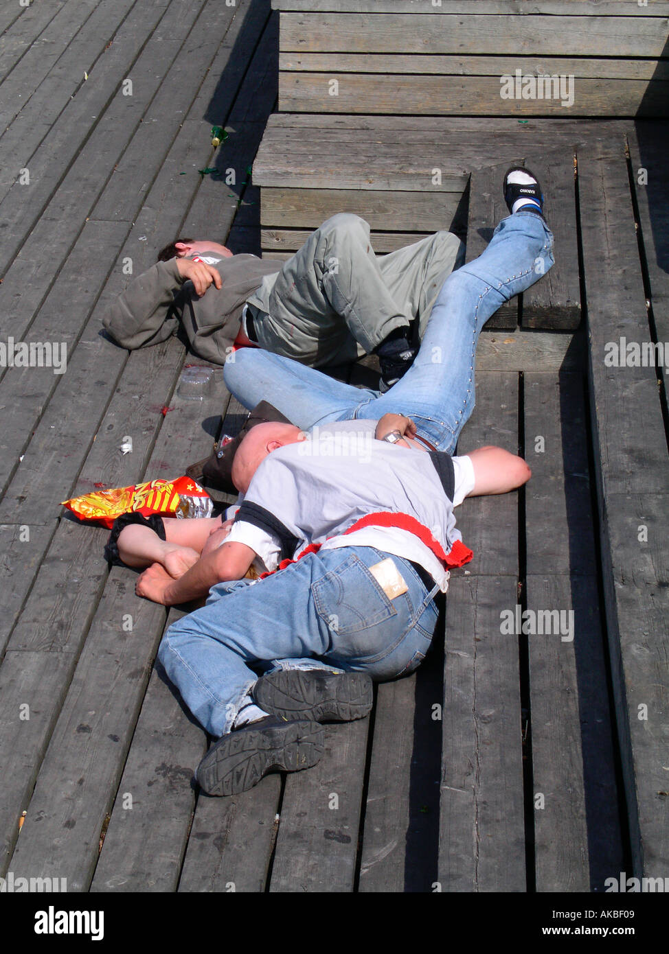 group of drunks sleeping together outdoors Stock Photo