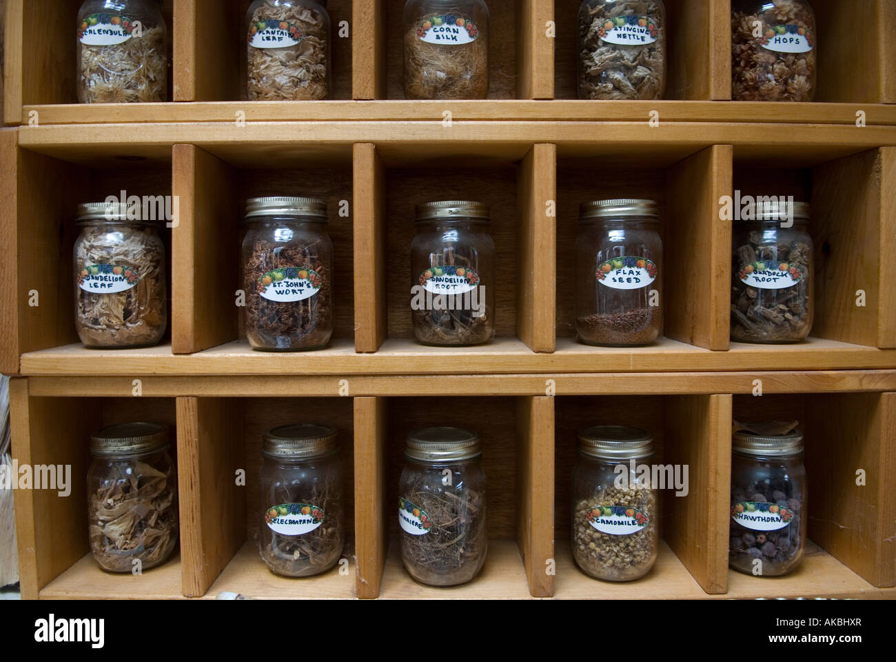 Spice rack with glass jars and labeled spice jars Stock Photo - Alamy