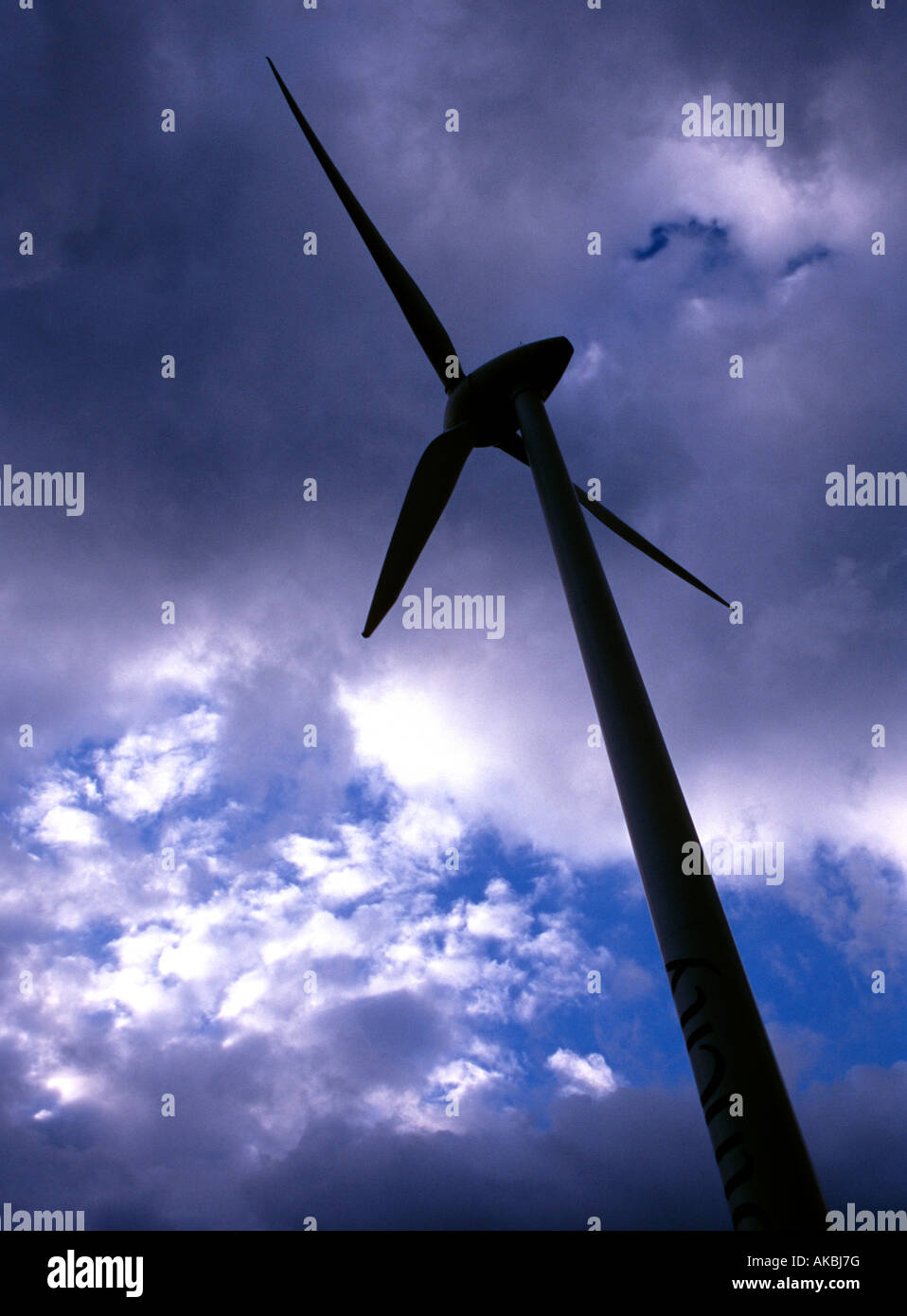 Wind turbine against cloudy sky Stock Photo - Alamy