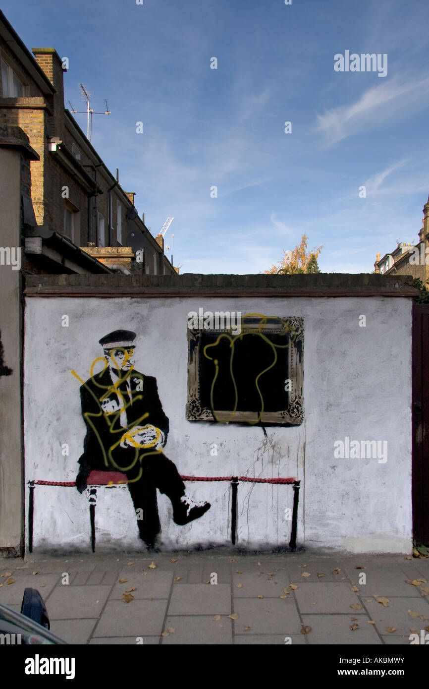 Vandalised grafitti artwork by the guerilla artist Banksy near Arsenal