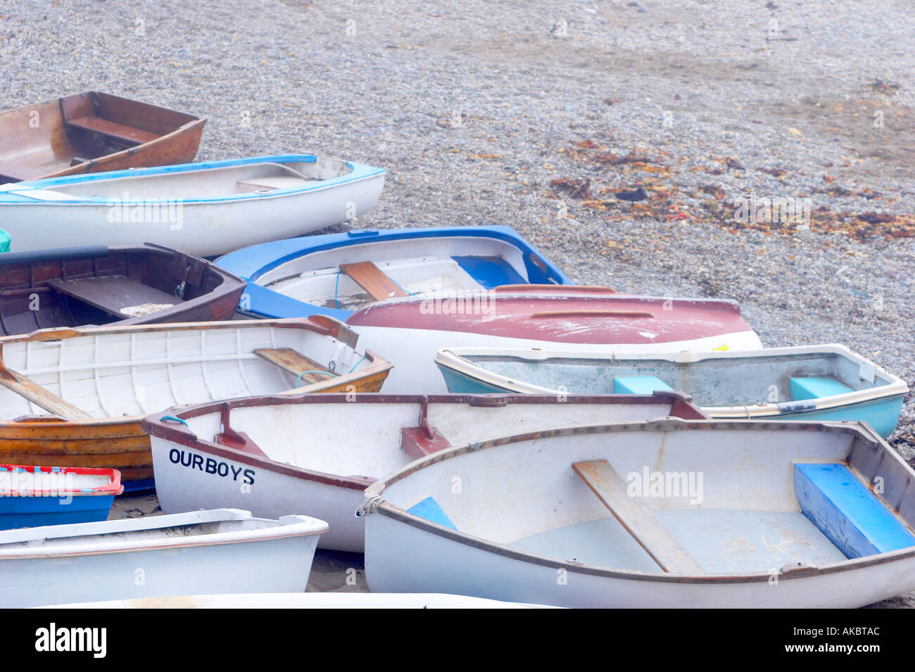 Small boats on beach in bad weather Stock Photo Alamy