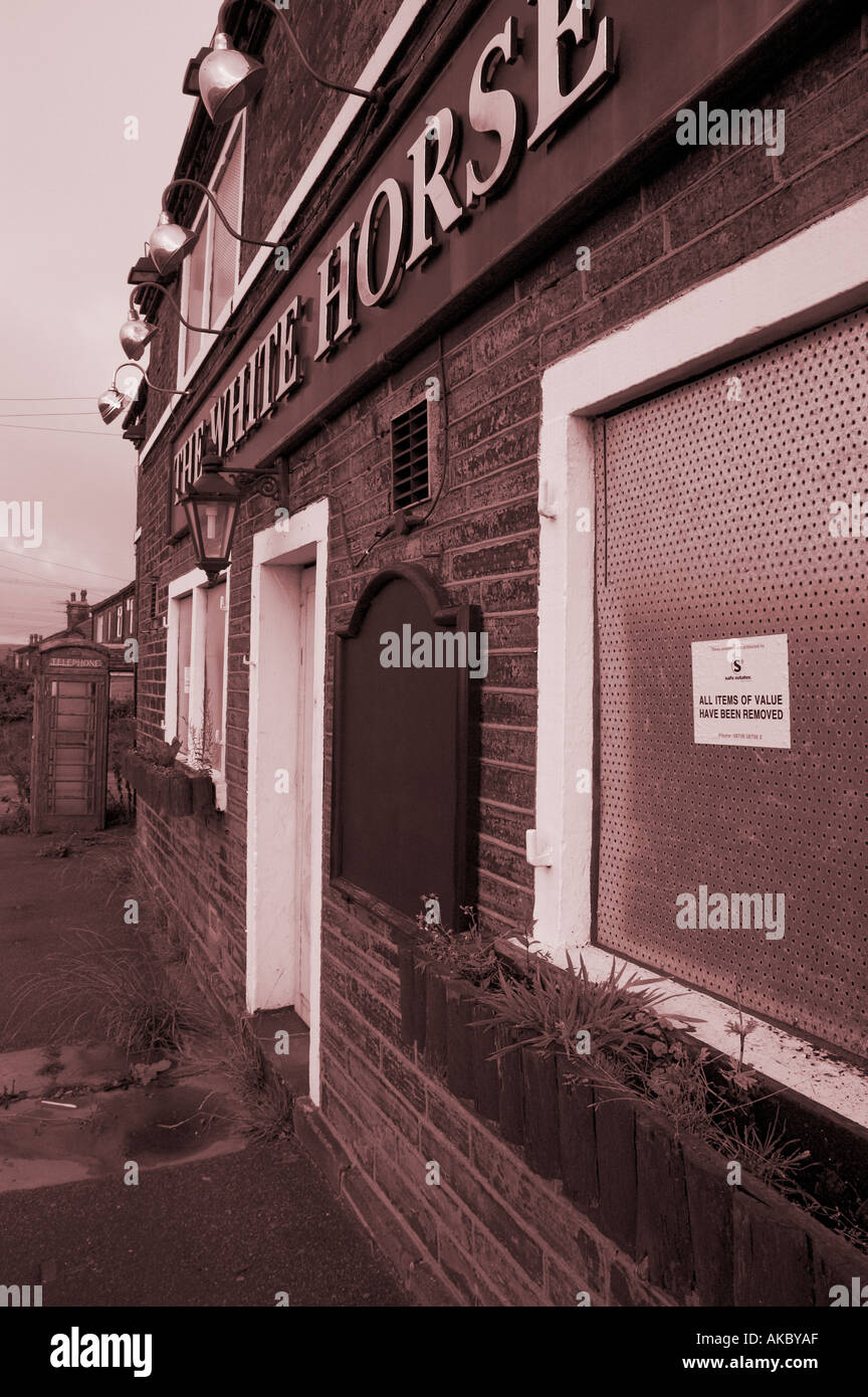 Closed and boarded up pub Stock Photo