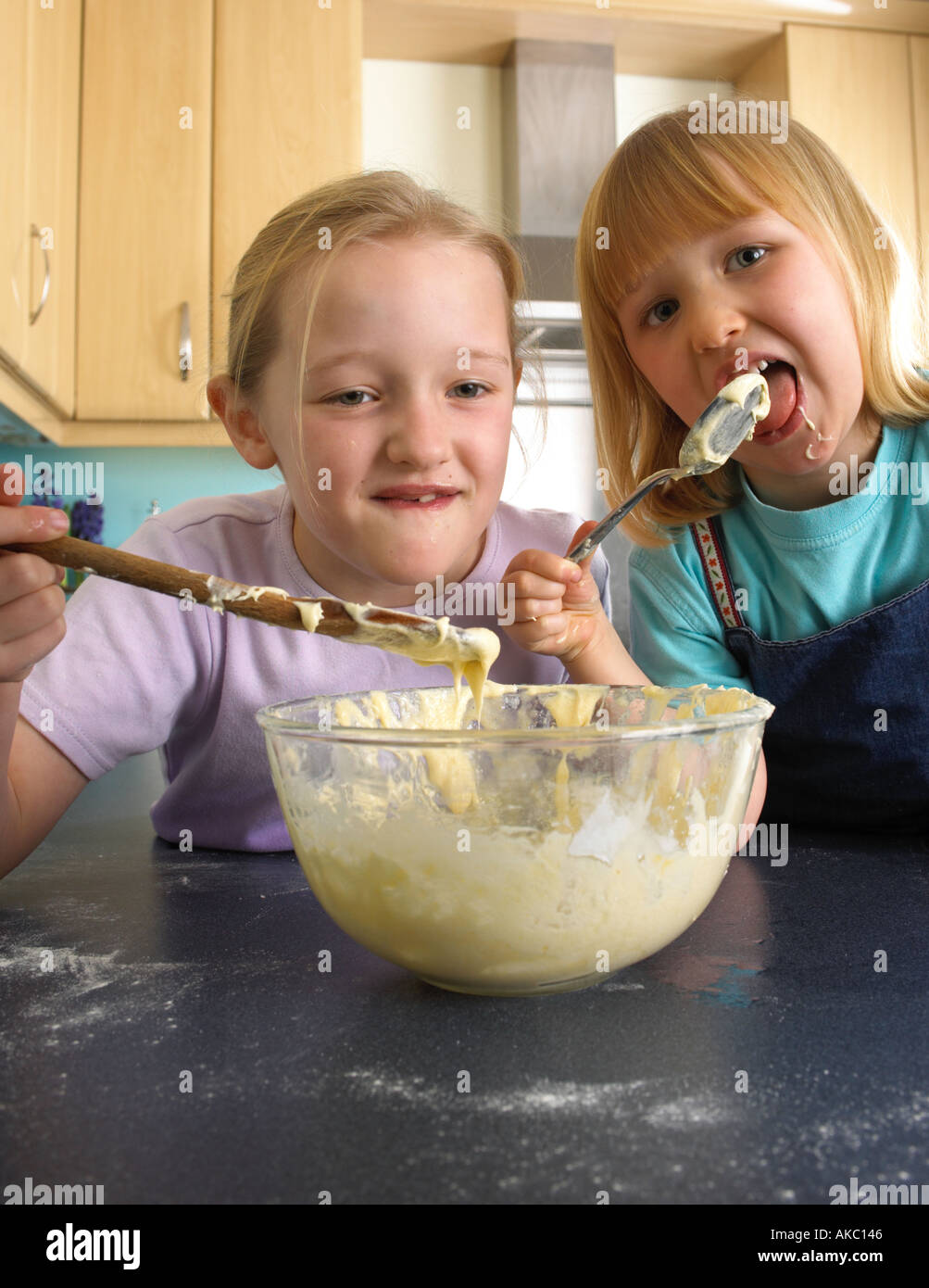 Children cooking cakes in their kitchen at home Stock Photo