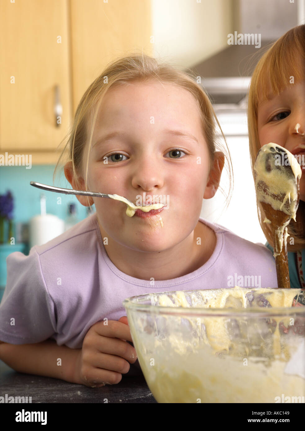 Children cooking cakes in their kitchen at home Stock Photo