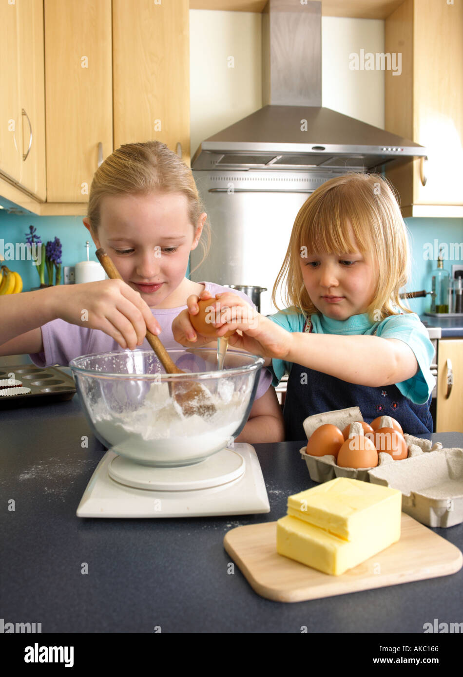 Children making cakes in the kitchen at home Stock Photo