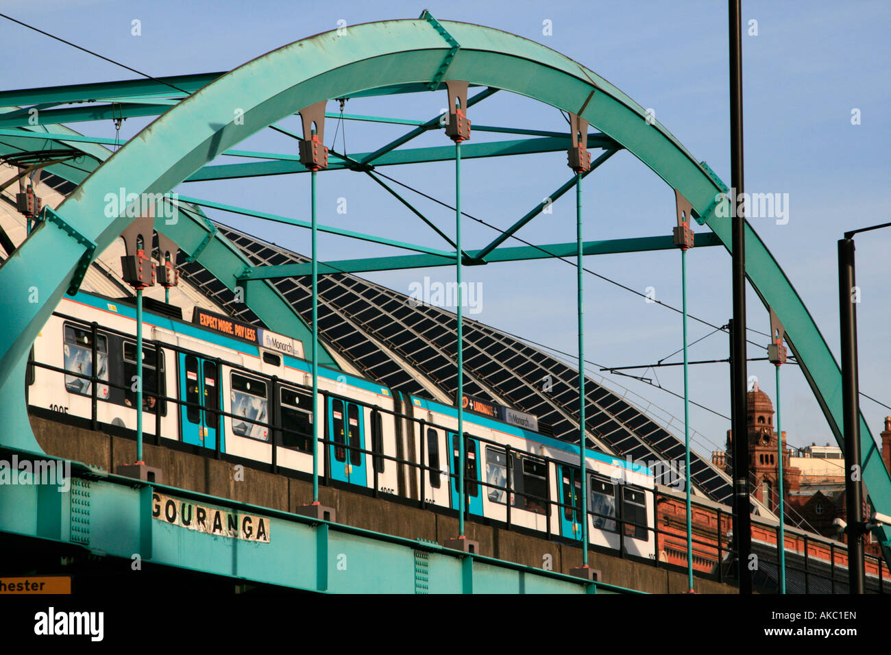 Manchester Metrolink is an urban light-rail system in Greater Manchester here a tram is crossing a steel bridge Stock Photo