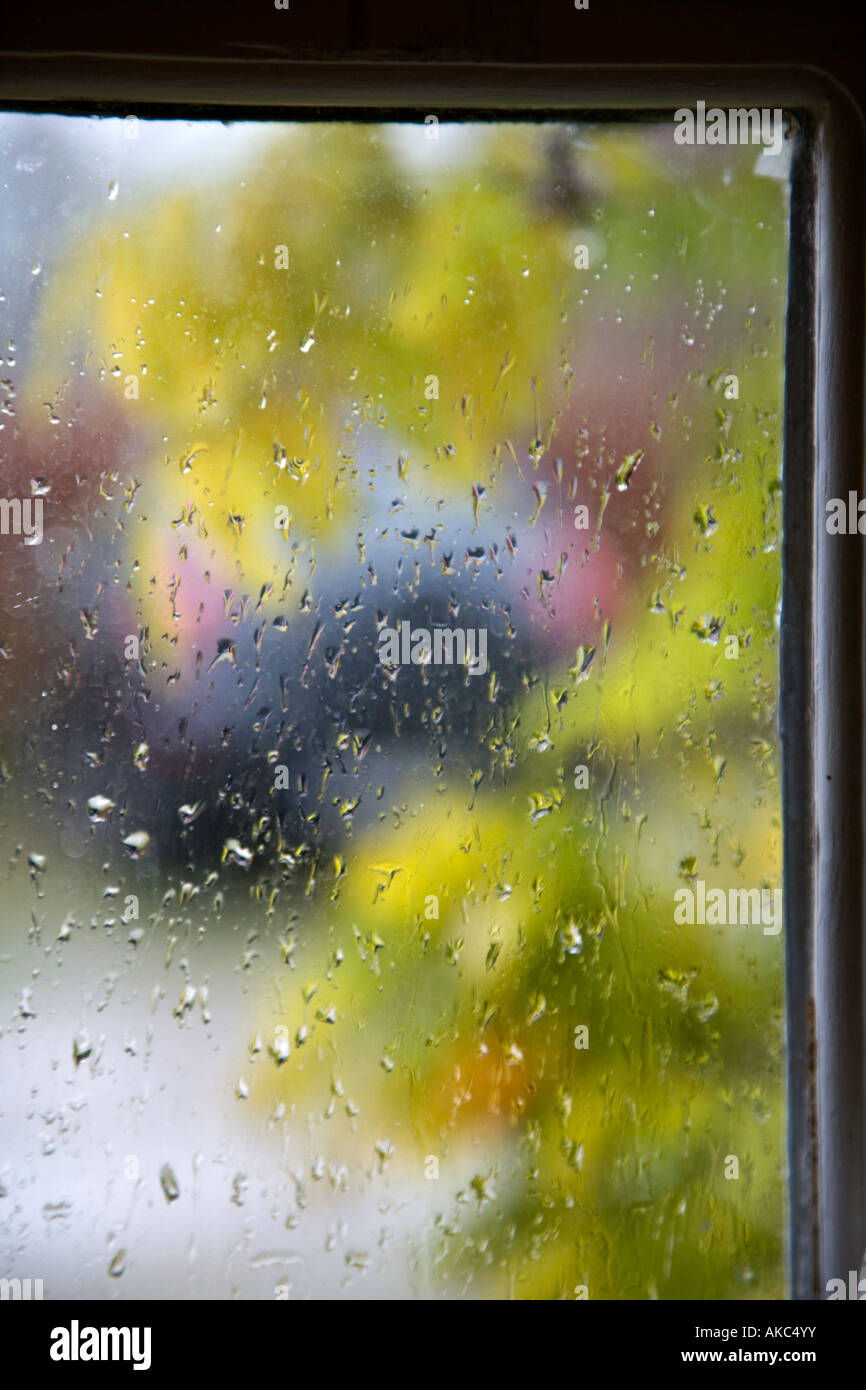 Raindrops on window pane with car Stock Photo Alamy