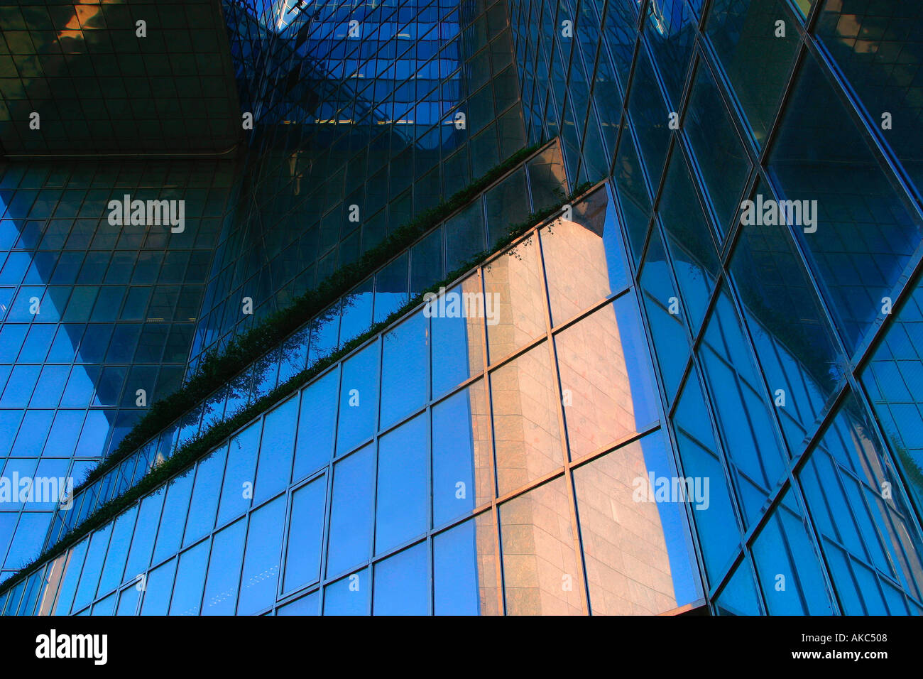 office builing with blue sky reflected in glass windows Stock Photo