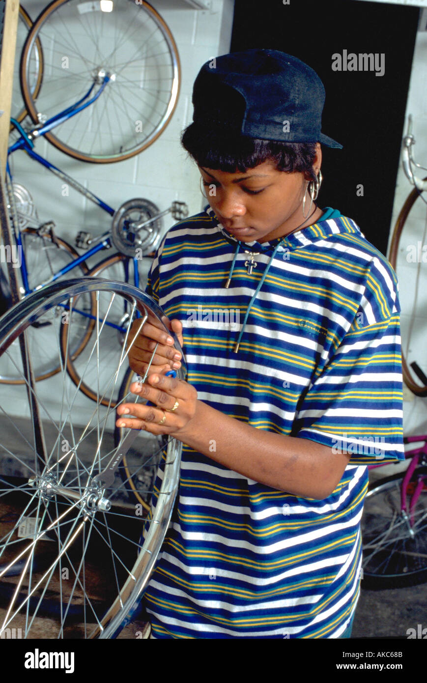 Worker age 15 fixing tire at Youth Express Community Bike Shop. St Paul Minnesota USA Stock Photo Alamy