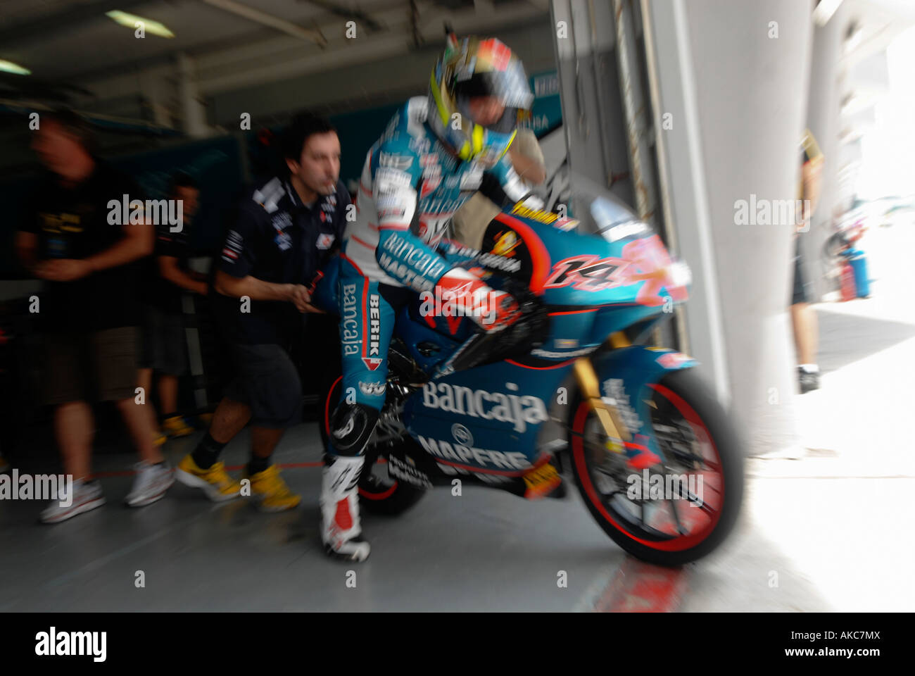 Zoom burst effect of 125cc rider Gabor Talmacsi being pushed at race day Stock Photo