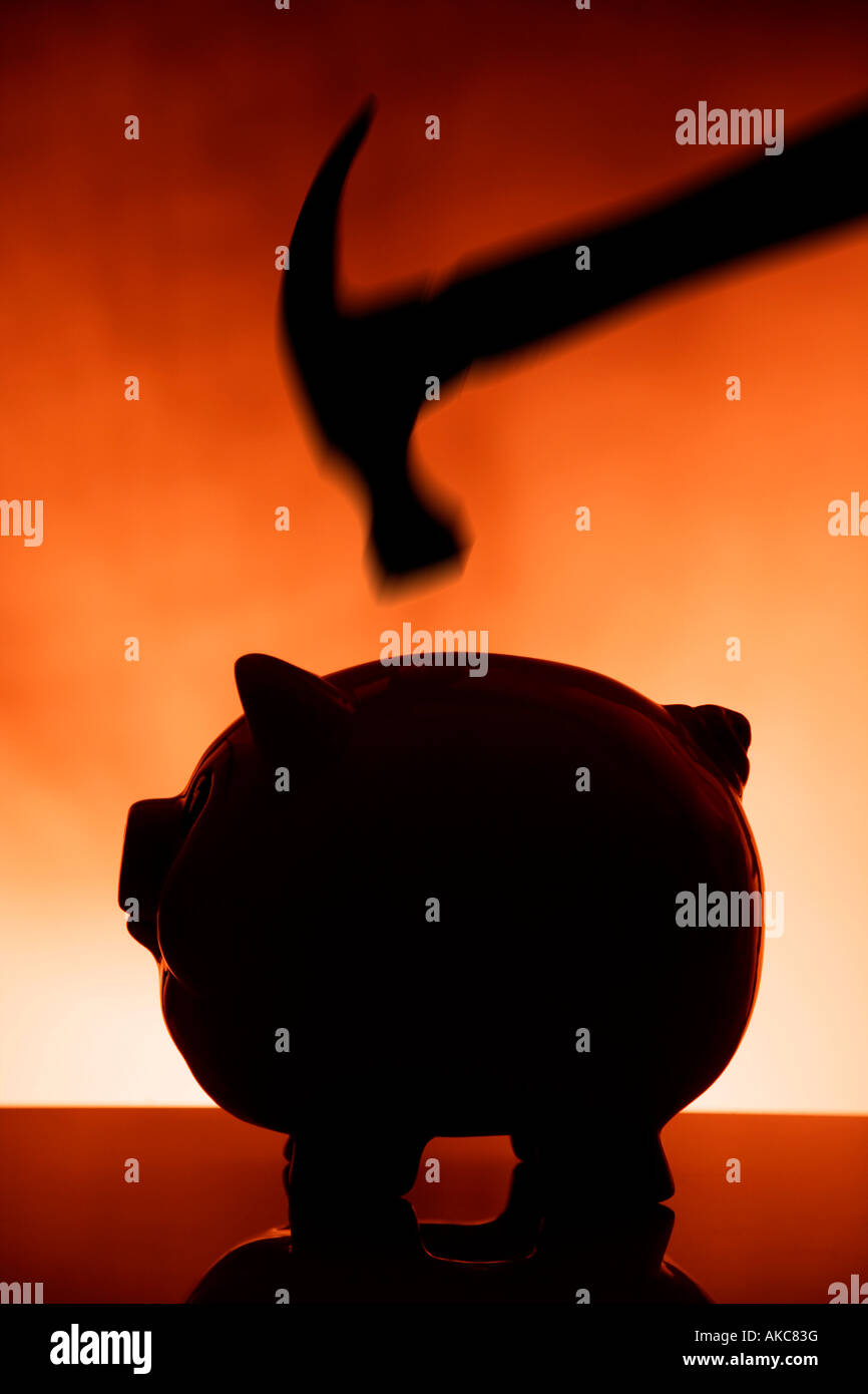 Hammer smashing piggy bank Stock Photo - Alamy