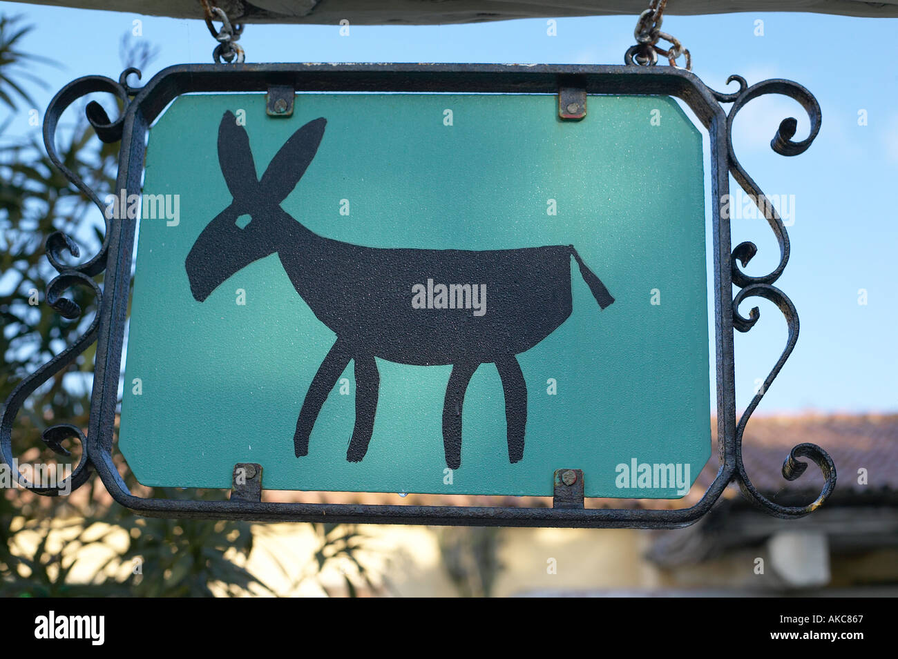 Donkey logo for Ca La Somara guest farm Sardinia on swing sign and covered  in morning dew Stock Photo - Alamy