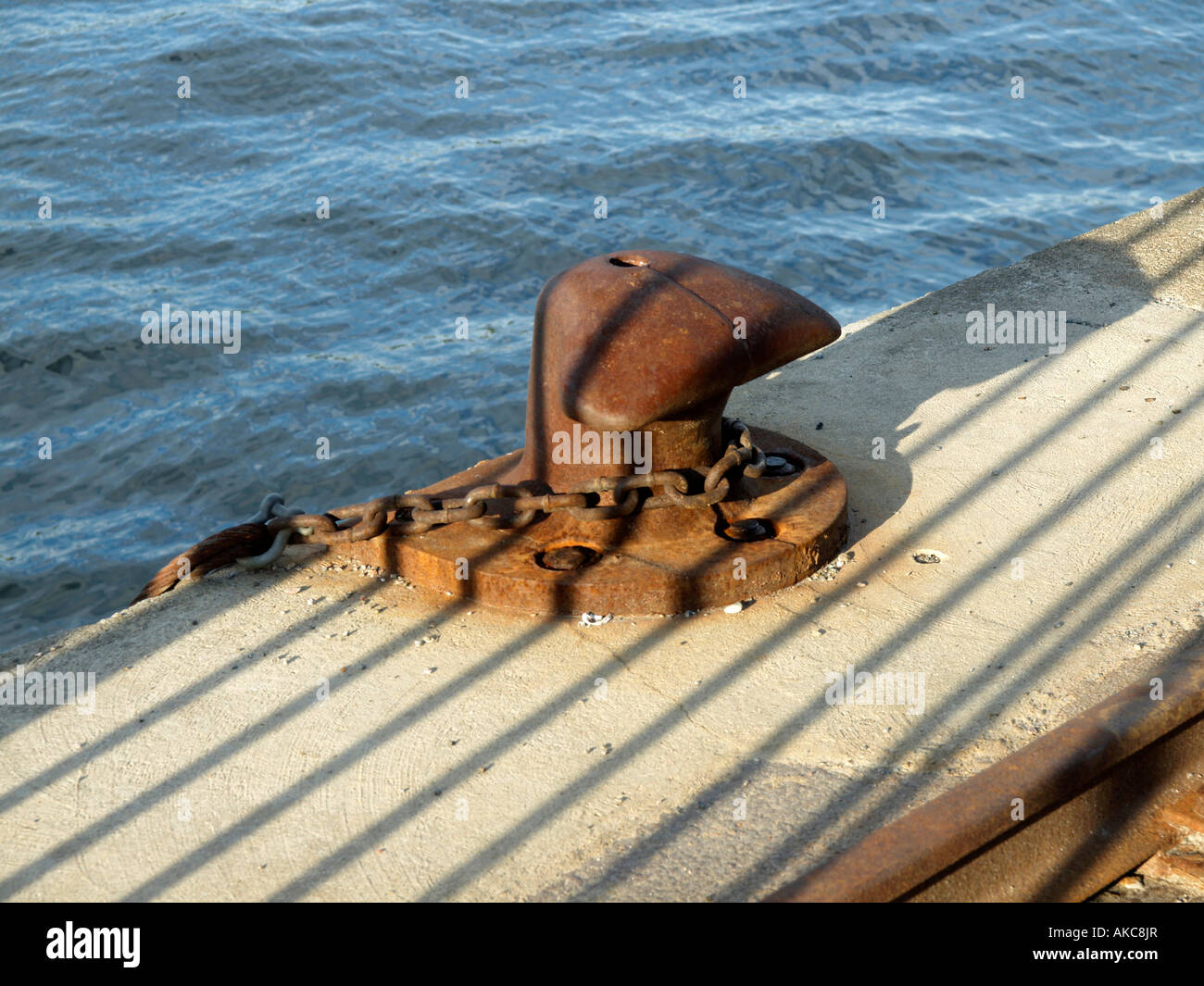bollard on ships dock with iron chain Stock Photo