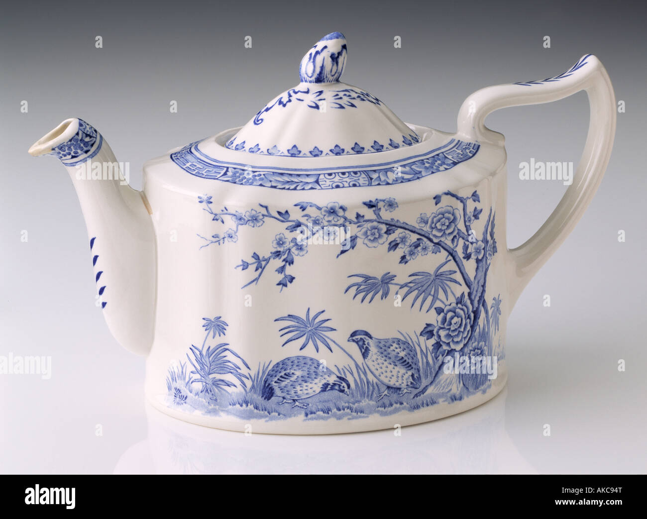 An antique Wedgwood teapot willow pattern on a white background Stock