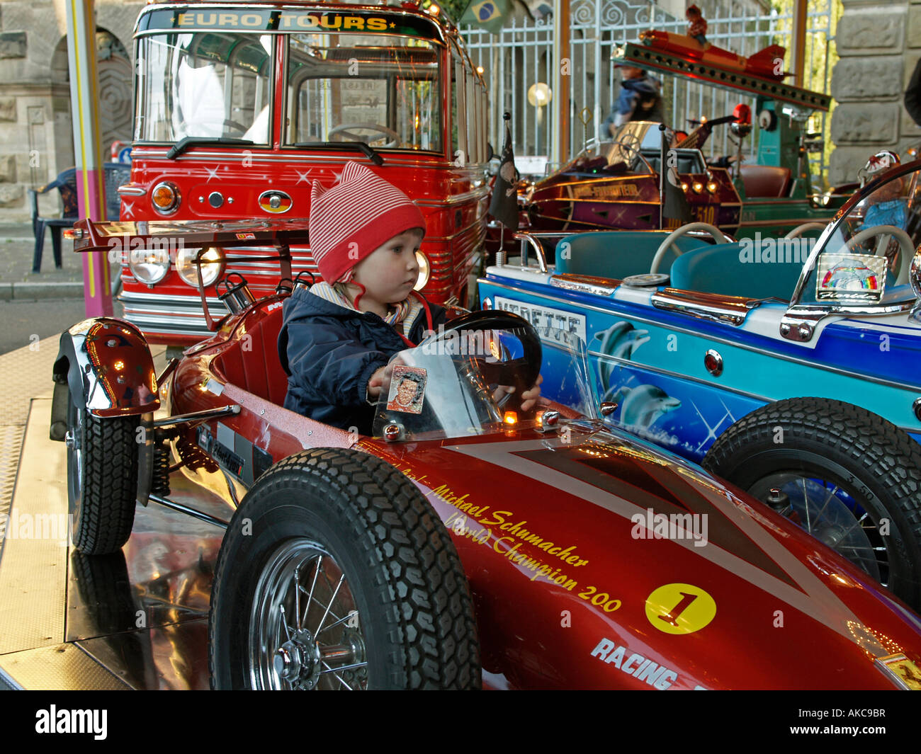 little child driving in a car of kids merry go round roundabout Stock ...