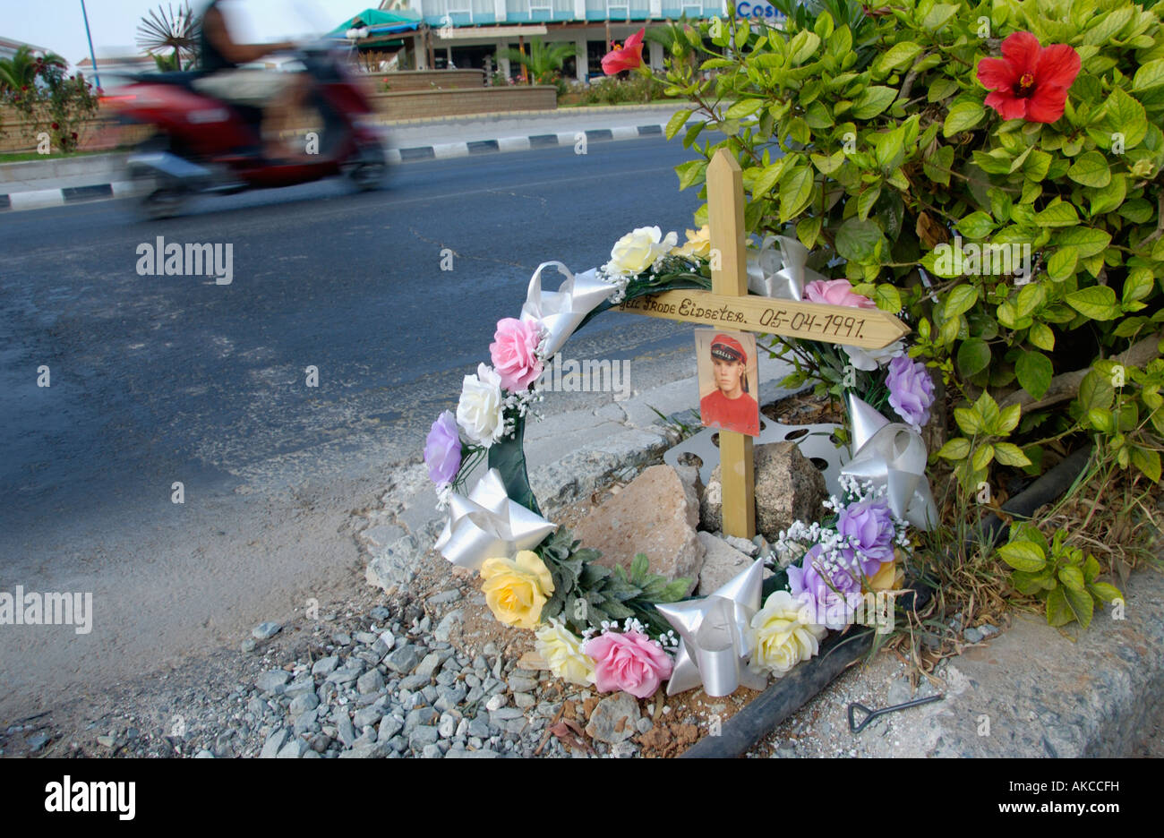 Roadside memorial wreath and cross with photo on the Mediterranean ...