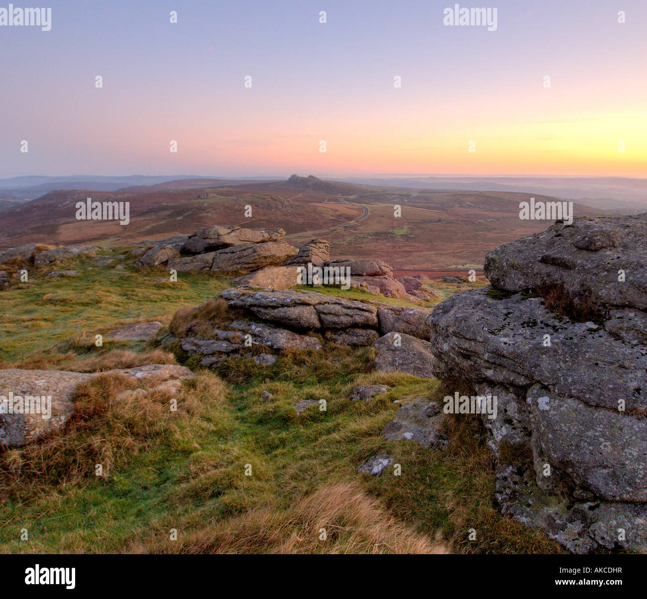 Pastel coloured sunrise at Rippon Tor Dartmoor South Devon England with Hay Tor in the middle distance Stock Photo
